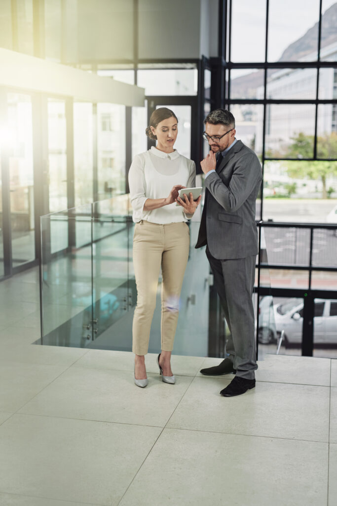 Meeting, discussion and business people with tablet in office for feedback, report review or project proposal. Lens flare, corporate consultant and staff for conversation, collaboration or teamwork